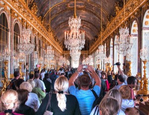 Crowds surge into the Hall of Mirrors at the Palace of Versailles in France. Photo by John Kroll.